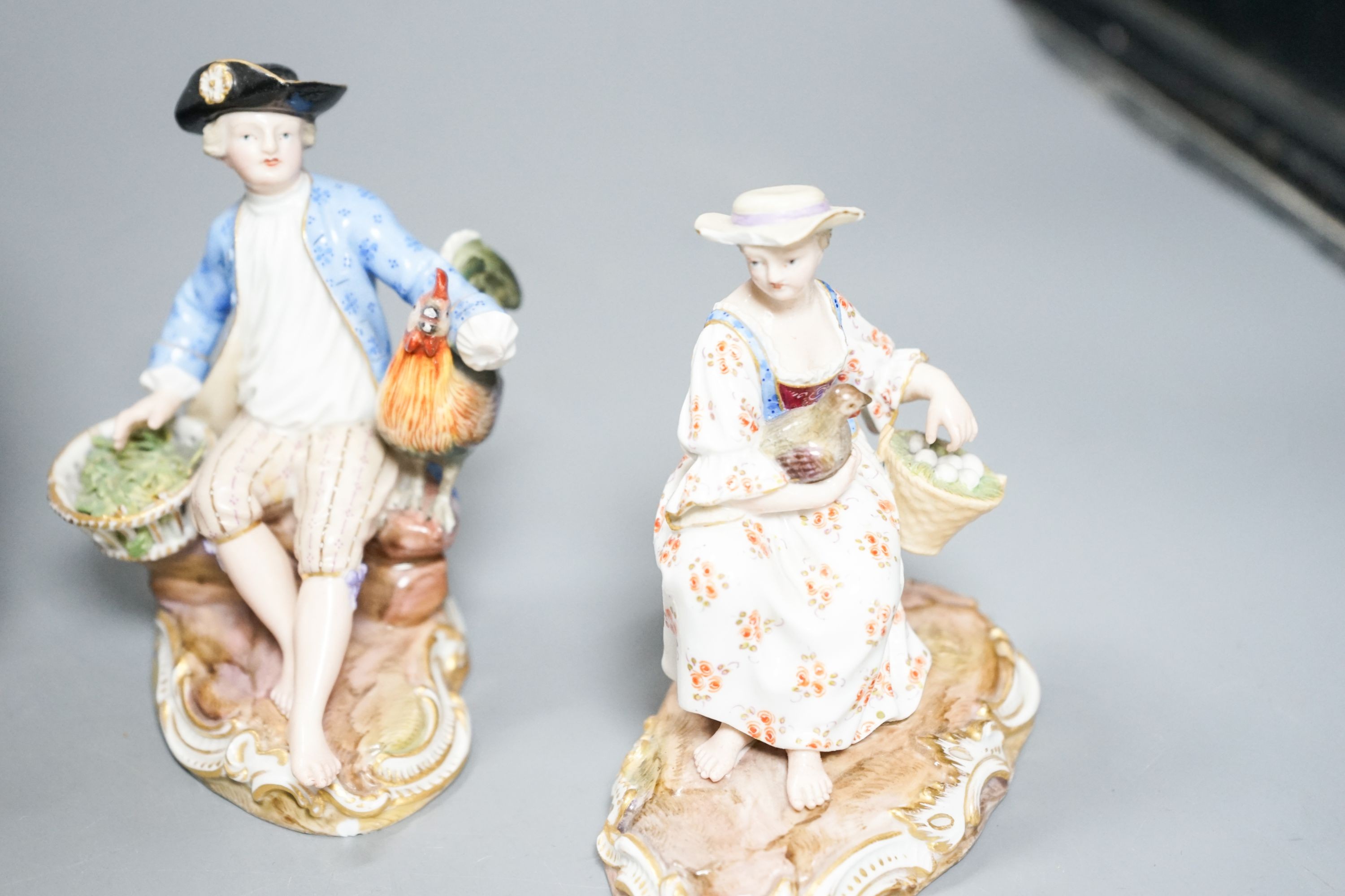 A pair of Meissen groups holding chickens, 10.5cm, a pair of Sitzendorph figures and a Sitzendorf mirror 18cm